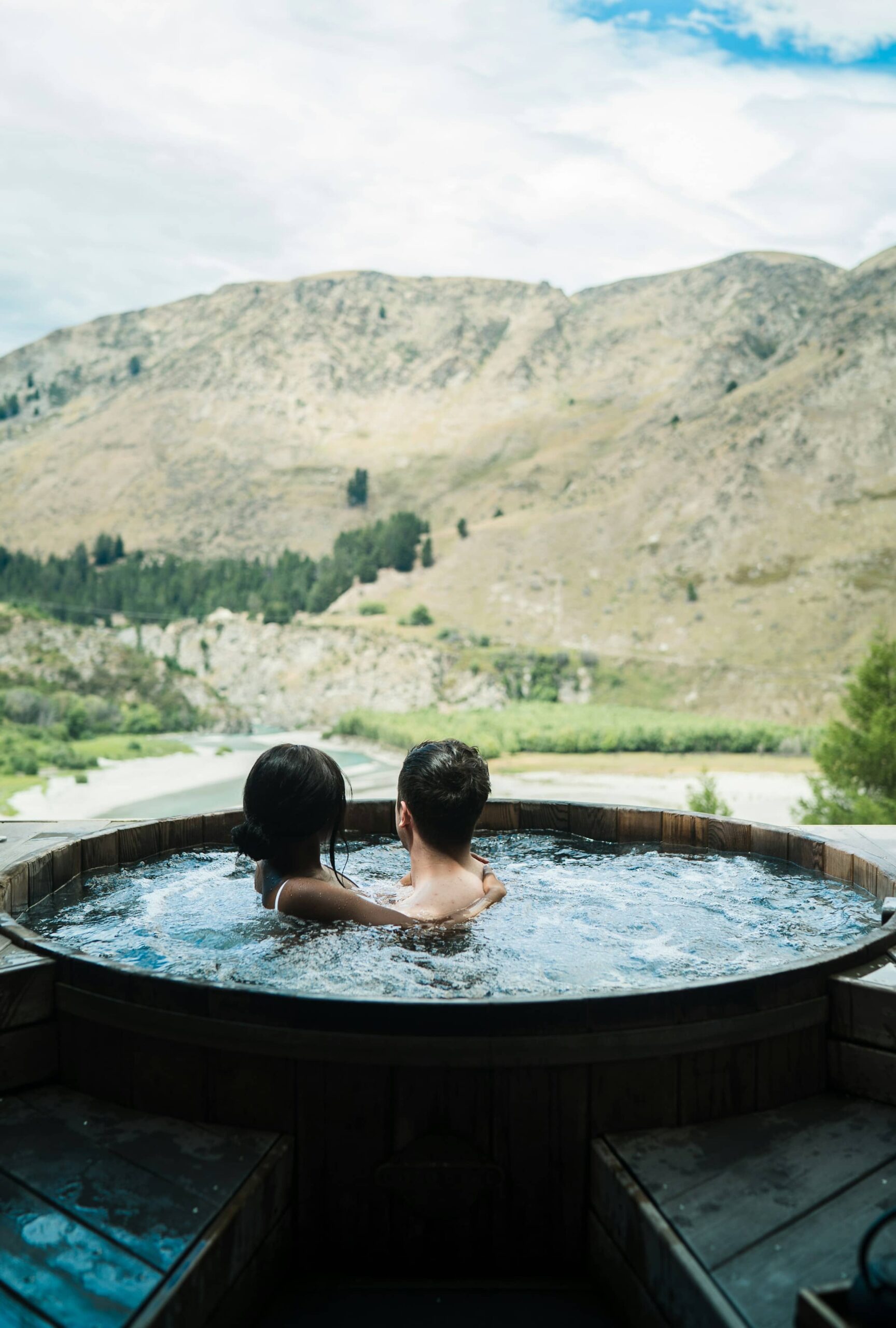 a couple in a hot tub looking at the view